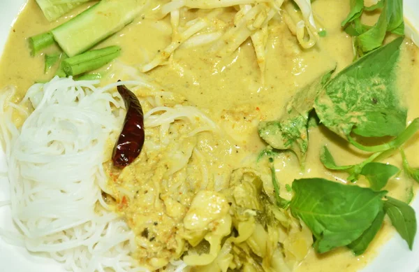 rice noodles dressing crab coconut milk curry sauce and fresh vegetable on plate