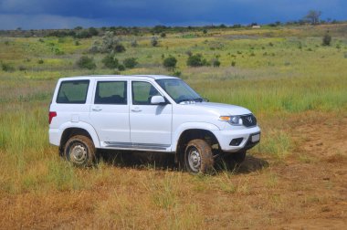 KRASNODAR KRAY, RUSSIA - 21 Haziran 2020: Rus SUV UAZ Patriot yeşil çimlerle kaplı tepelik bir alanda 