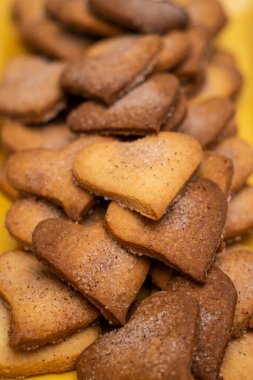 Basit ev yapımı kalp şeklinde kurabiyeler, şeker ve tarçınla süslenmiş.