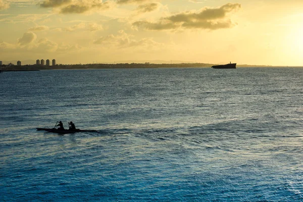Sunset on the sea of Fortaleza Brazil with silhouette of a shipwreck