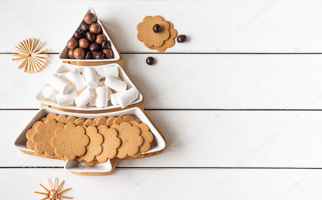 Sweet treats on a Christmas-tree-shaped sectional plate