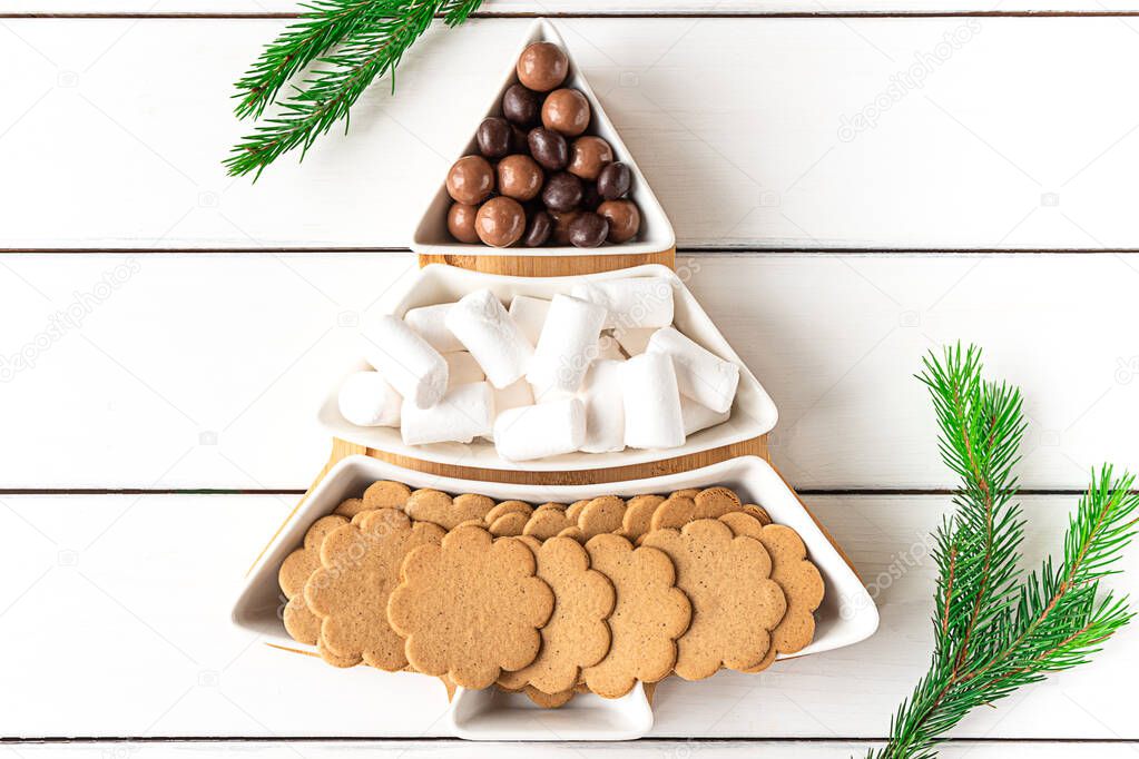 Sweet treats on a Christmas-tree-shaped sectional plate