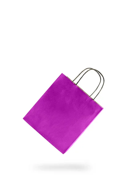 Fialová barva papíru nákupní taška na bílém izolovaném pozadí. Prázdná cenovka visí pro vložení textu. — Stock fotografie