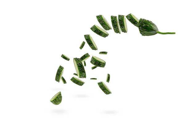 Falling cucumber slices on white isolated background. The cucumber scatters. Cut fresh cucumber into slices hanging in the air. — Stock Photo, Image