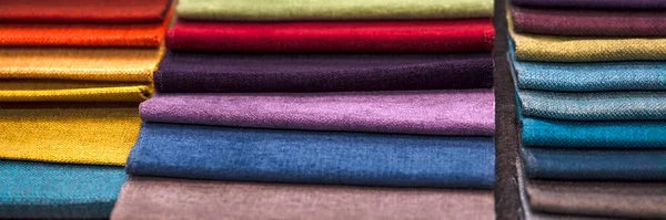 Samples of textiles for upholstery. Closeup details of multicolor fabric texture samples. Samples of different colors: red, blue, yellow, green, brown. — Foto Stock