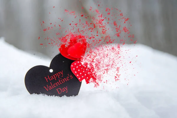 Happy Valentines Day greeting card or banner. Red hearts on a branch of a snow-covered tree in winter. Holidays Happy Valentines Day. Red heart shatters into pieces — 图库照片