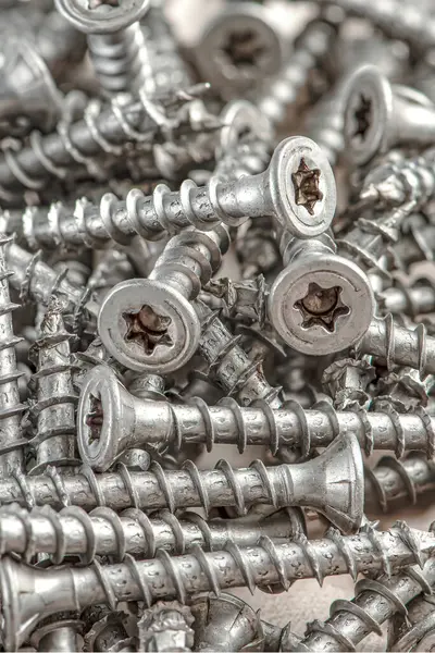 Close-up of universal silver screws with torx head. Self-tapping screws for wood, plywood or chipboard. Torx screws close up. — Stock Photo, Image