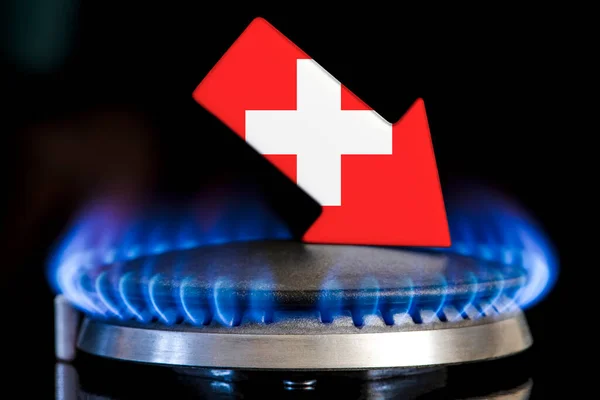 Decreased gas supplies in Switzerland. A gas stove with a burning flame and an arrow in the colors of the Switzerland flag pointing down. Concept of crisis in winter and lack of natural gas
