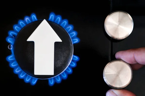 Gas price. Supply chains and the energy gas crisis. Gas stove with a burning flame and a graph arrow pointing up.