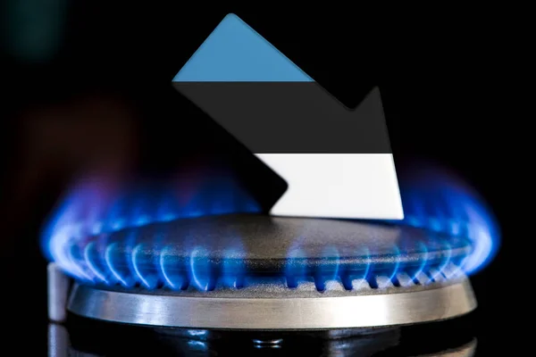 Decreased gas supplies in Estonia. A gas stove with a burning flame and an arrow in the colors of the Estonia flag pointing down. Concept of crisis in winter and lack of natural gas. Heating season