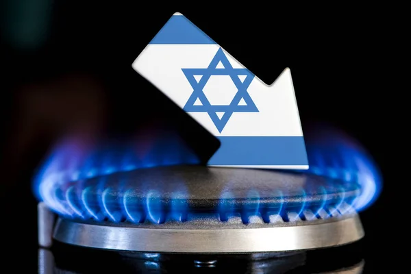 Decreased gas supplies in Israel. A gas stove with a burning flame and an arrow in the colors of the Israel flag pointing down. Concept of crisis in winter and lack of natural gas. Heating season