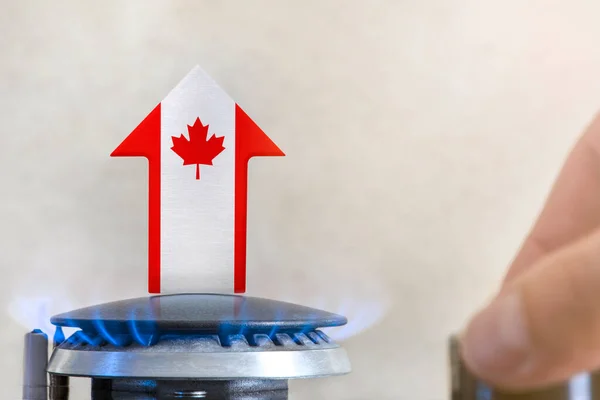 Gas price. Rise in gas prices in Canada. A burner with a flame and an arrow up, painted in the colors of the Canada flag. The concept of rising gas or energy prices