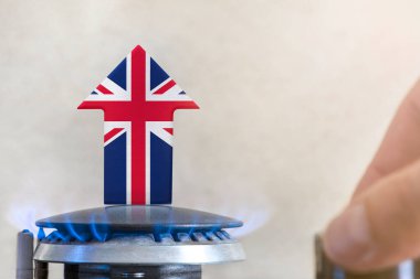 Gas price. Rise in gas prices in United Kingdom. A burner with a flame and an arrow up, painted in the colors of the United Kingdom flag. The concept of rising gas or energy prices
