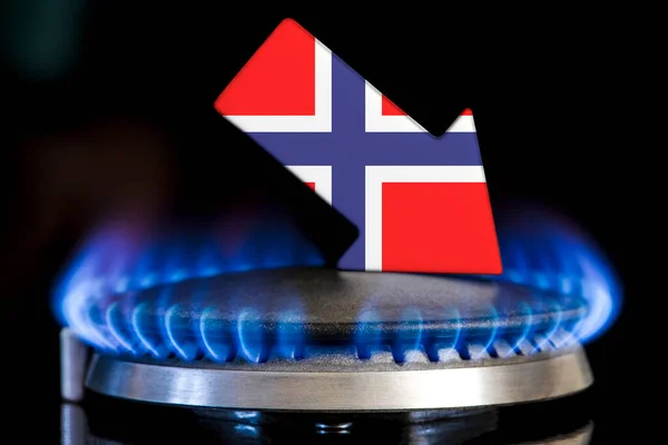 Decreased gas supplies in Norway. A gas stove with a burning flame and an arrow in the colors of the Norway flag pointing down. Concept of crisis in winter and lack of natural gas. Heating season