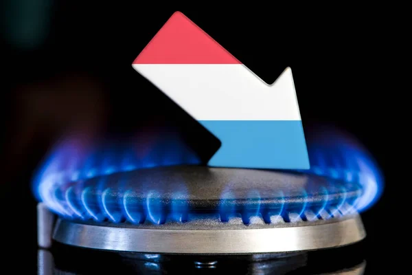 Decreased gas supplies in Luxembourg. A gas stove with a burning flame and an arrow in the colors of the Luxembourg flag pointing down. Concept of crisis in winter and lack of natural gas
