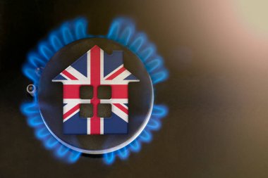 gas crisis. Rising utility costs in United Kingdom. Energy crisis, export-import problems in United Kingdom. The concept, gas burner and house model are colored in the colors of the flag