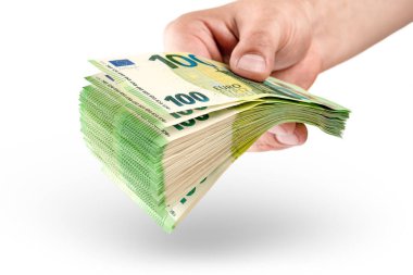 Stack of money in hand isolated on white background. 100 euro banknotes in a mans hand. A man holds out his hand with a stack of banknotes as a concept for a loan, insurance or mortgage