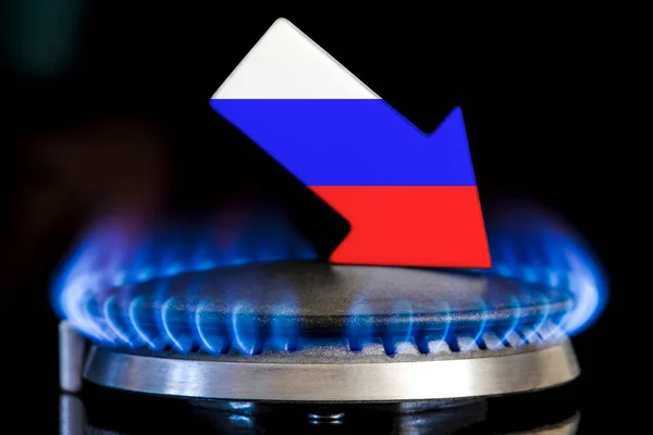Decreased gas supplies Russia. A gas stove with a burning flame and an arrow in the colors of the Russia flag pointing down. Concept of crisis in winter and lack of natural gas. Heating season