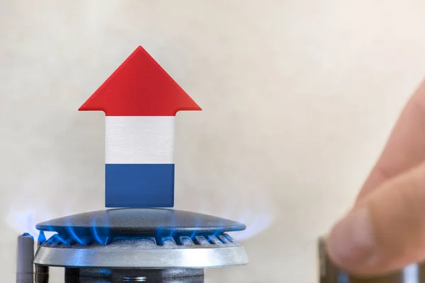 Gas price. Rise in gas prices in Netherlands. A burner with a flame and an arrow up, painted in the colors of the Netherlands flag. The concept of rising gas or energy prices