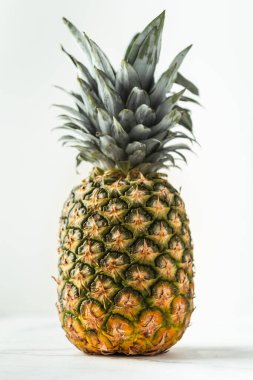 Beyaz arka planda bütün ananas izole edilmiş. Dikey çekim. Tropik hissi olan yaz arkaplanı