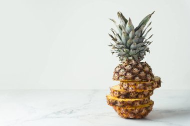 ripe pineapple cut into pieces on a white background. Close up. Juicy fruit