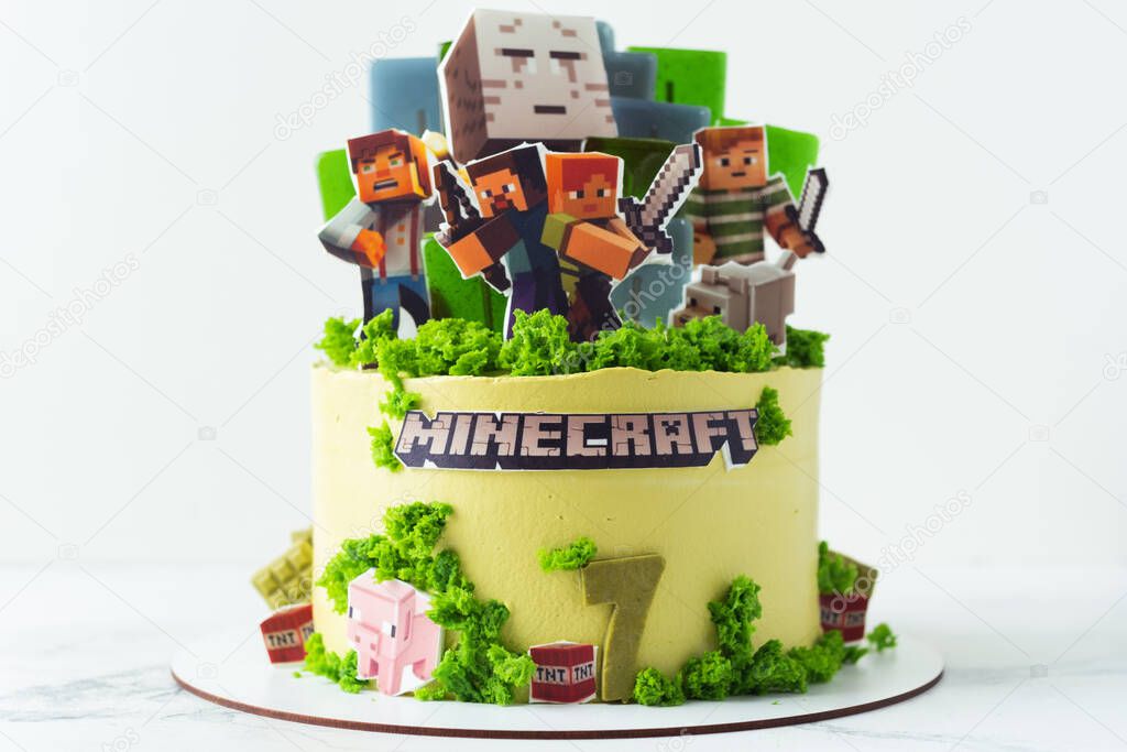 KYIV, UKRAINE - June 24: Birthday cake for a fan of Minecraft game on white background. Cake for a gameboy decorated with edible green grass