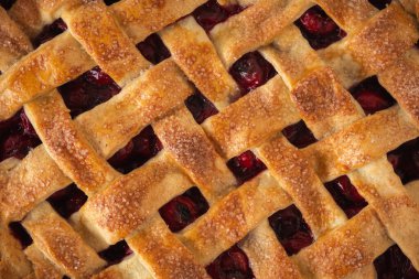 Delicious homemade cherry pie with Flaky Crust as a textured background. American traditional pastry. Flat lay. Fresh summer berry tart dessert
