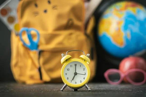 Yellow Backpack School Supplies Next Globe Red Apple Glasses Blurred — Stock fotografie