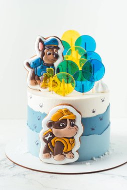 Kyiv, Ukrayna - 10 Ağustos - Paw Patrol animasyon televizyon dizisinin Chase ve Moloz köpek yavruları şeklinde zencefilli kurabiyelerle süslenmiş küçük bir hayranı için beyaz ve mavi doğum günü pastası