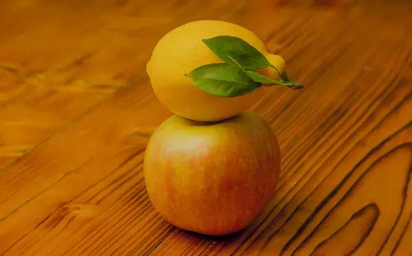 Sarı sulu limon ve olgun bir elma. eski ahşap arka planda