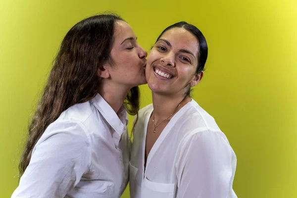 Young Female Couple Kiss Cheek Yellow Background — Foto Stock