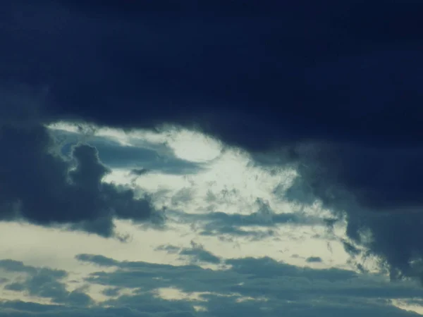 White and black clouds on a blue sky