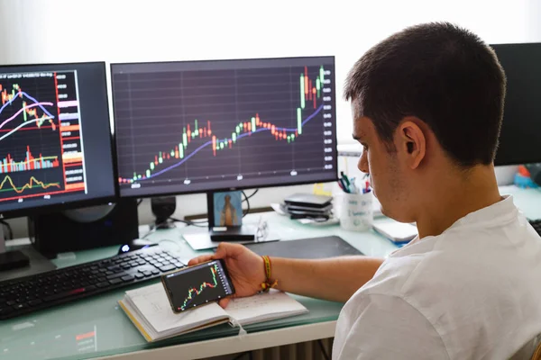 Successful young trader in casual wear working with charts and market reports at home — Stock Photo, Image