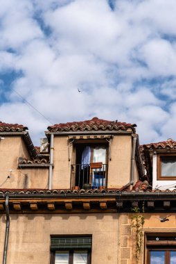 Old attic window in tiled roof in Malasana Quarter in central Madrid