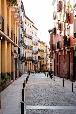 Madrid, Spain - October 17, 2020: Typical street in Lavapies amidst old residential buildings in Lavapies in Madrid. This is one of the trendiest quarters of Madrid