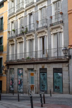 Madrid, Spain - October 17, 2020: Typical street in Lavapies amidst old residential buildings in Lavapies in Madrid. This is one of the trendiest quarters of Madrid