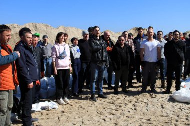Odessa, Ukrayna 16 Mart 2022 'de Odessa sakinleri kendilerini organize ederek şehir plajından gelen kum torbalarını doldurdular. Çantalar Odessa, Ukrayna sokaklarındaki stratejik noktaları ve barikatları korumak için kullanılacak..