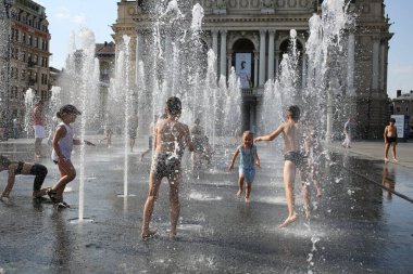Lviv, Ukraine,30, June, 2022 Children bathe in a fountain near the building Lviv National Academic Opera and Ballet named after Solomia Krushelnitskaya
