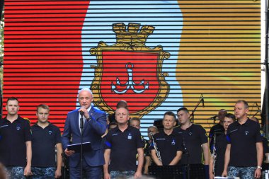 Odessa, UkraineSeptember,2,2022.Day of the city of Odessa, city mayor Gennady Trukhanov delivers a speech against the background of the emblem of the city.