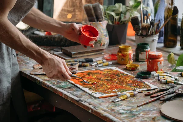 Painter in workspace creating modern art — Stock Photo, Image