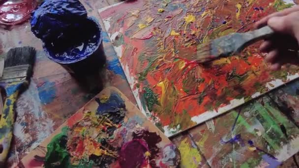 Painter in workspace creating modern art — Stockvideo