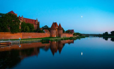 Marienburg castle the largest medieval brick castle in the world in the city of Malbork evening view at night