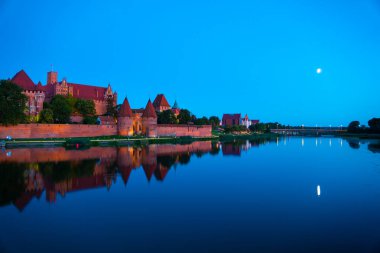 Marienburg castle the largest medieval brick castle in the world in the city of Malbork evening view at night