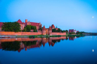 Marienburg castle the largest medieval brick castle in the world in the city of Malbork evening view at night