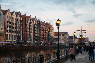 Scenic summer evening panorama of architectural twilight sunset evening street of the Old Town embankment Baltic port GDANSK, POLAND - July 6, 2022