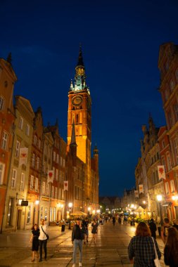 Scenic summer evening panorama of architectural pedestrians tourists people walk along the evening street of the Old Town GDANSK, POLAND - July 6, 2022