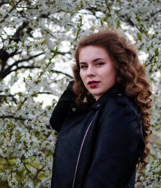 Baharda açık havada yürüyen uzun saçlı mutlu kız.