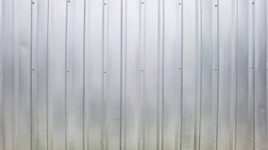 close up of grey metal sheet fence wall background.