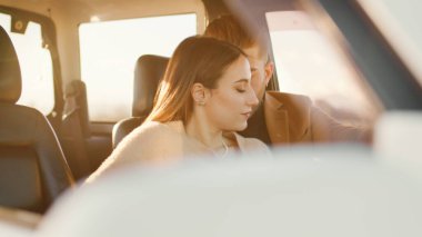 Happy boy and girl in the off road car during valentines day