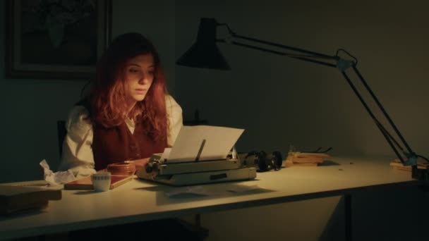 Meisje schrijft op de typemachine thuis zittend op tafel. — Stockvideo